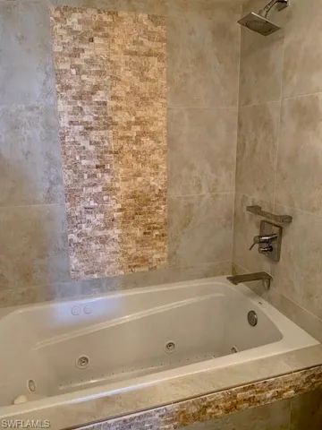 Guest Bathroom jetted tub with beautiful tile design