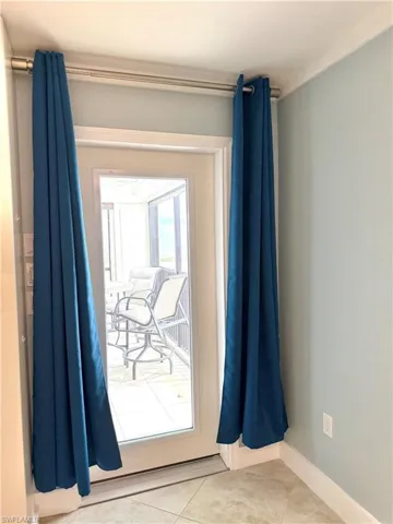 Primary bedroom door access to balcony.