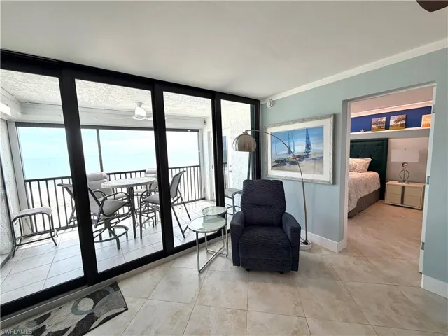 Sliding glass doors to balcony provide abundant light and sunset views