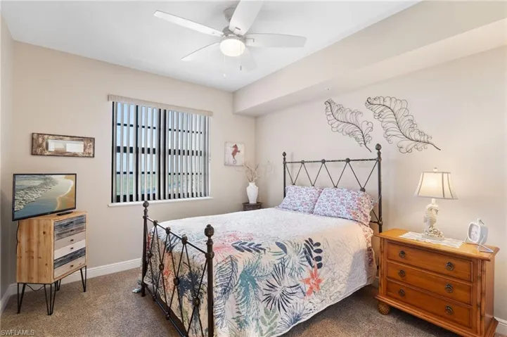 Bedroom featuring carpet floors, ceiling fan, and baseboards