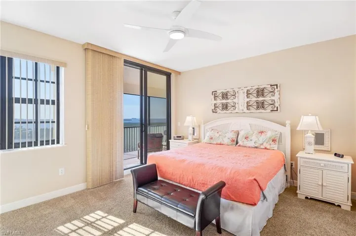 Bedroom with access to outside, carpet, ceiling fan, and baseboards