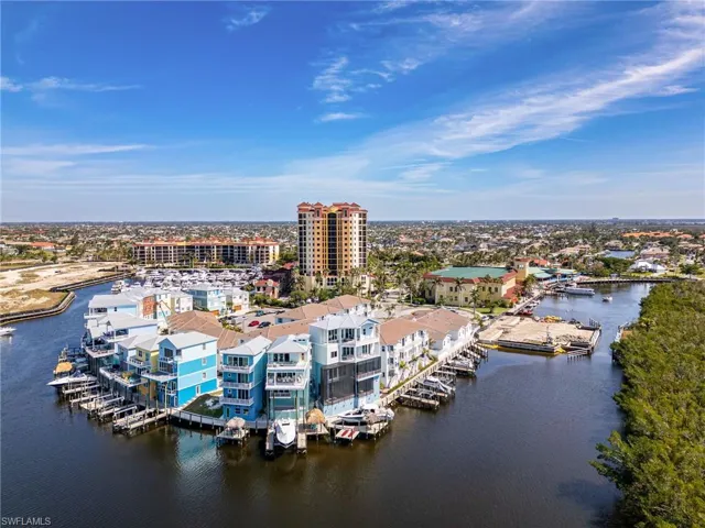 Birds eye view of property with a view of city and a water view