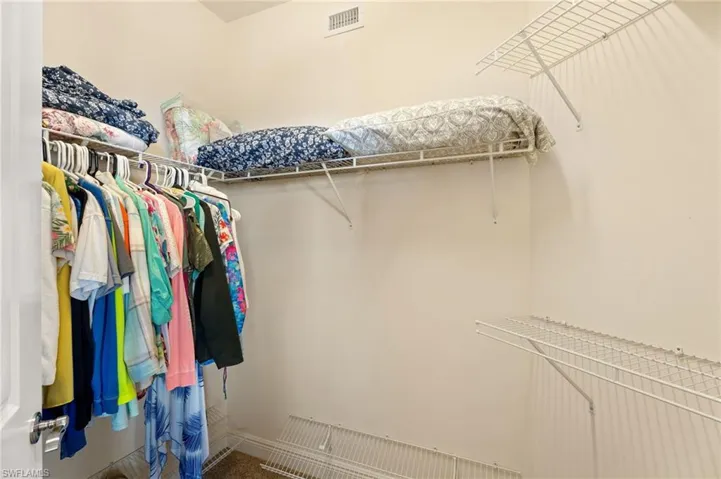 Spacious closet featuring visible vents