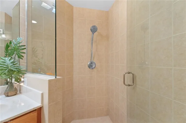 Full bathroom featuring a stall shower and vanity