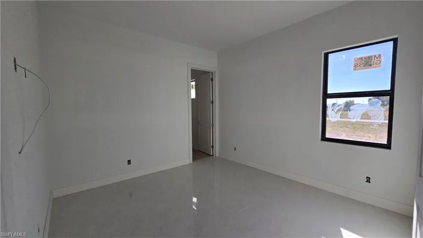 Empty room featuring baseboards