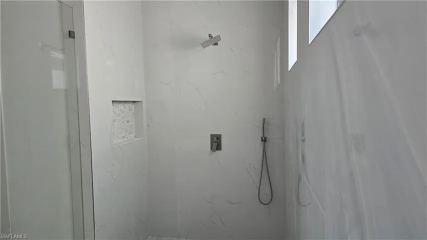 Bathroom view of a marble finish shower