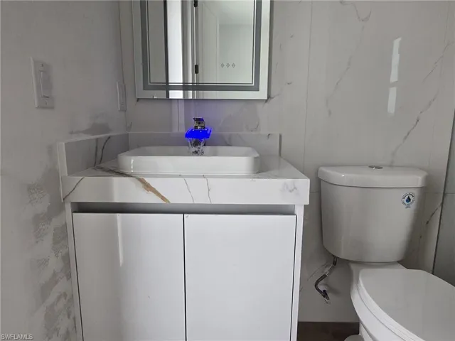 Bathroom featuring vanity and toilet