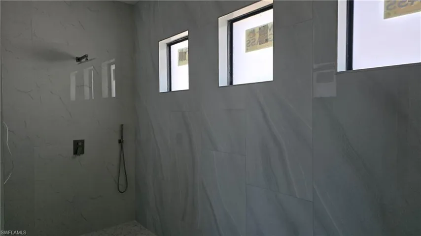 Bathroom featuring a marble finish shower
