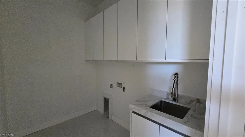 Laundry room with cabinet space and hookup for a washing machine