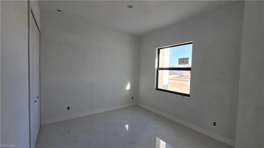 Unfurnished bedroom with a closet and baseboards