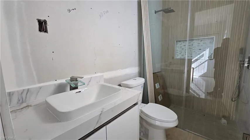 Full bath with vanity and a stall shower
