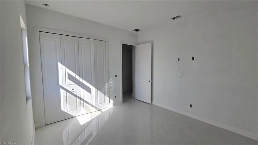 Unfurnished bedroom featuring a closet and baseboards