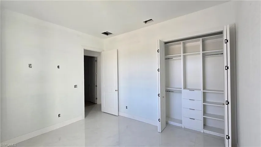 Unfurnished bedroom featuring baseboards and a closet
