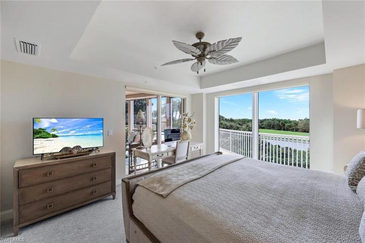 Primary bedroom also opens to the screened balcony.