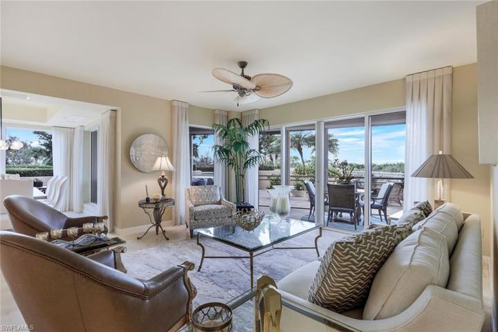 Living room with sliding doors leading to spectacular views of the lake below.