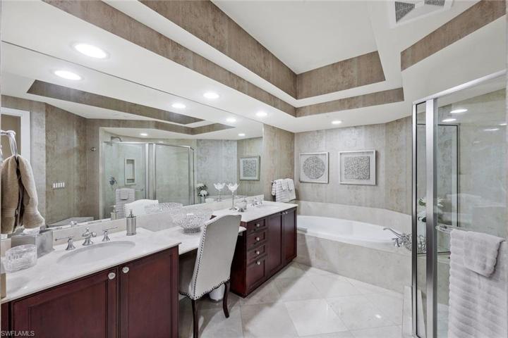 There is plenty of room for TWO in this primary en-suite bathroom. Walk in shower, soaking tub, two separate sink/counter areas, a vanity area and ample closet space accessible between bed and bath.