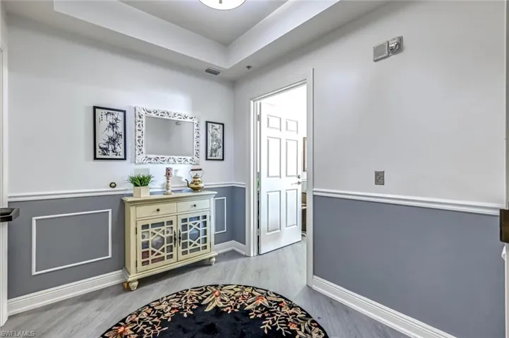 Entrance foyer featuring light wood-type flooring and a tray ceiling