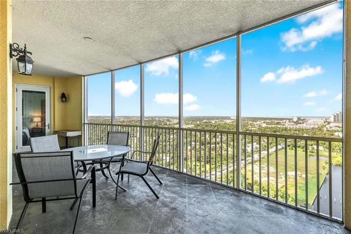 Sunroom / solarium featuring a balcony and outdoor dining area