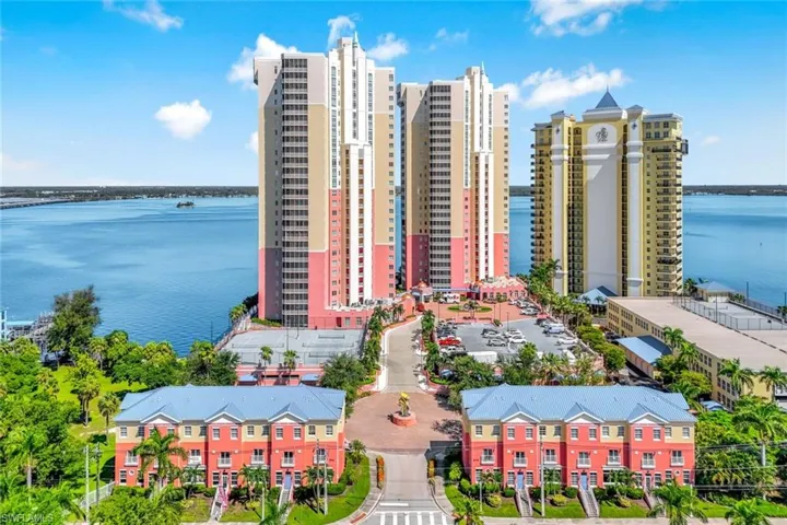 Drone / aerial view of apartment complex / building and a large body of water