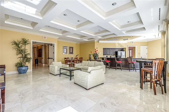 Community lobby featuring crown molding, coffered ceiling, and beam ceiling
