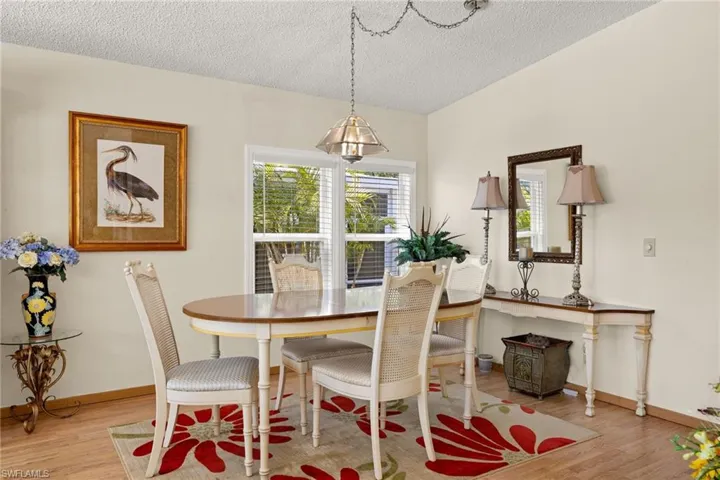 Dining room with a textured ceiling and light hardwood / wood-style flooring