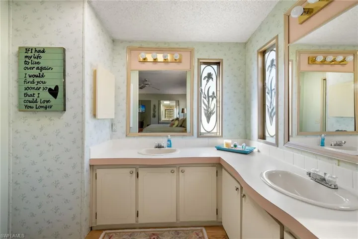 Bathroom featuring ceiling fan, a textured ceiling, and vanity