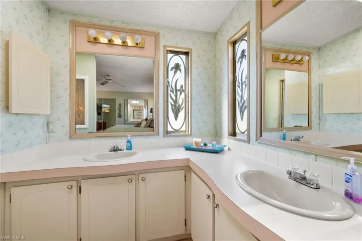 Bathroom featuring ceiling fan and vanity