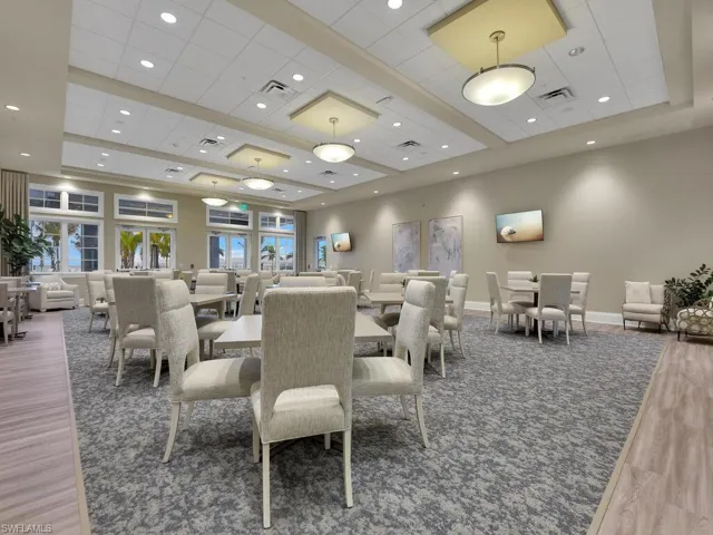 Dining space featuring hardwood / wood-style flooring, a drop ceiling, and a tray ceiling