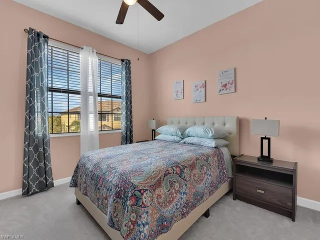 Bedroom featuring light colored carpet and ceiling fan