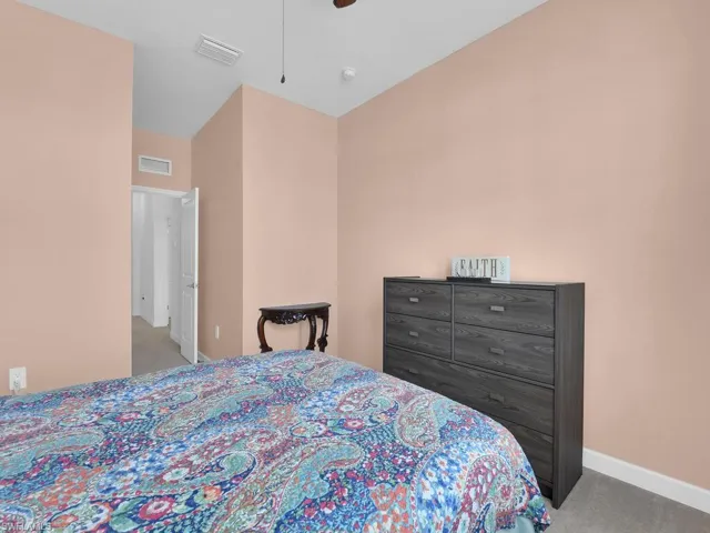 Carpeted bedroom with ceiling fan