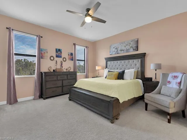 Bedroom featuring ceiling fan and light colored carpet