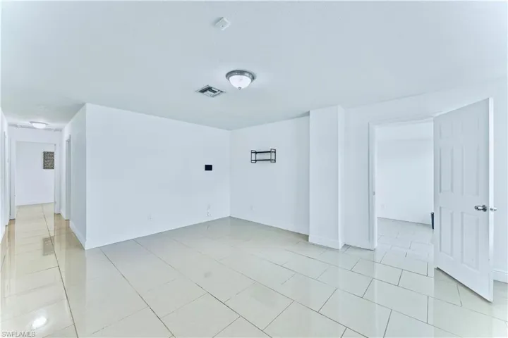 Spare room with light tile patterned floors and baseboards