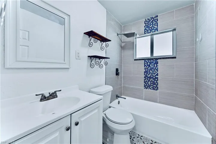 Full bathroom with vanity and bathtub / shower combination