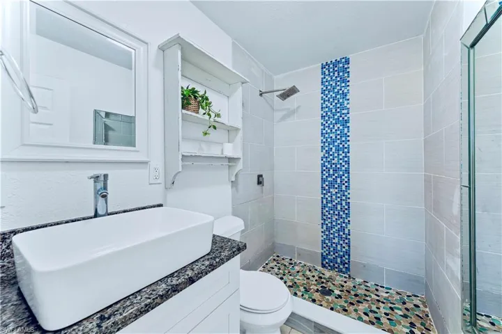Full bathroom featuring vanity and a stall shower