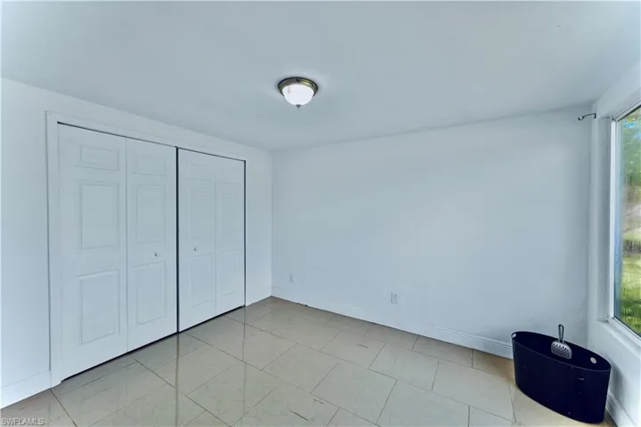 Unfurnished bedroom with baseboards and a closet