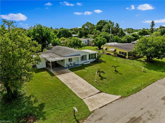 View from above of property featuring a tree filled landscape