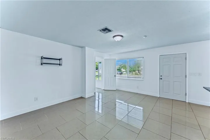 Spare room featuring light tile patterned floors and a textured ceiling