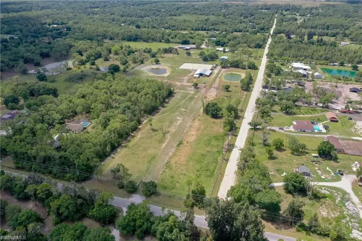 Aerial view of property's location featuring a heavily wooded area and rural landscape