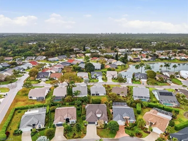 Aerial perspective of suburban area with a nearby body of water