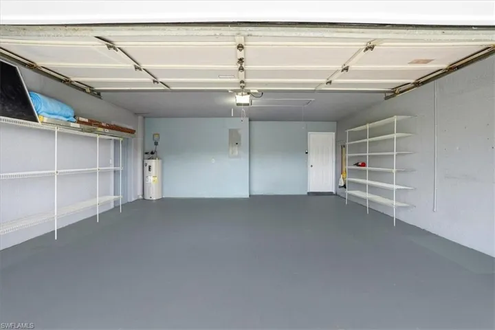 Garage with electric water heater and electric panel