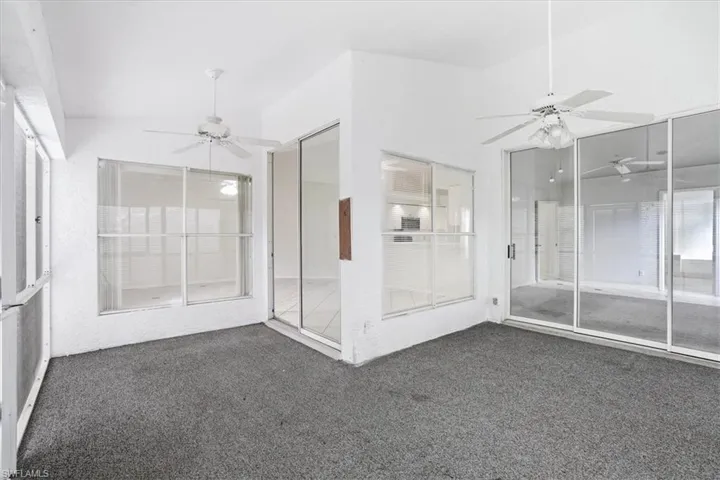 Unfurnished sunroom featuring a ceiling fan and lofted ceiling