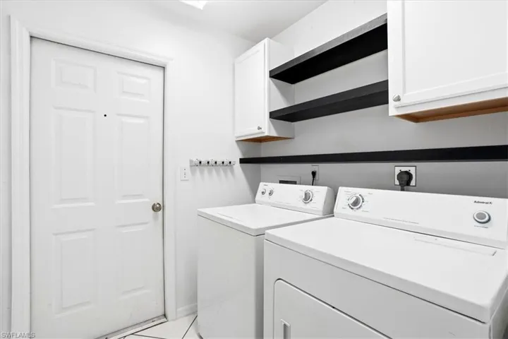 Laundry area featuring cabinet space and separate washer and dryer