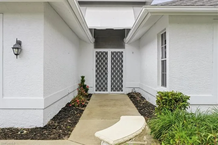 Property entrance featuring stucco siding