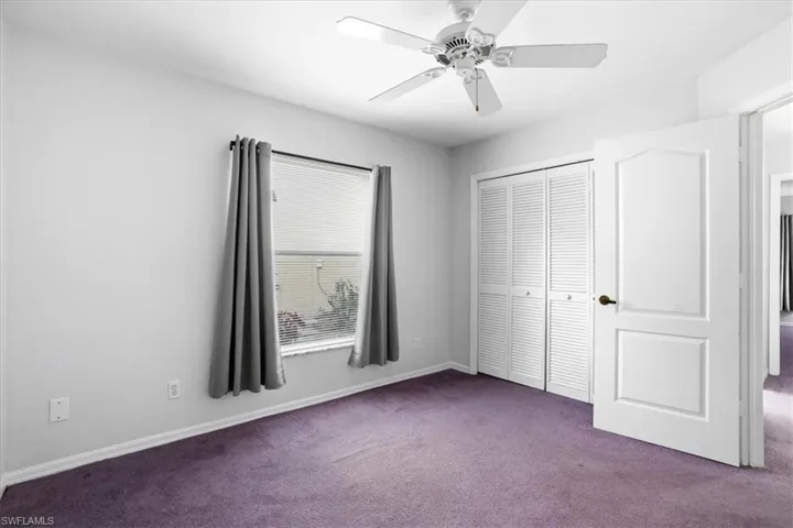 Unfurnished bedroom with carpet flooring, a closet, and ceiling fan