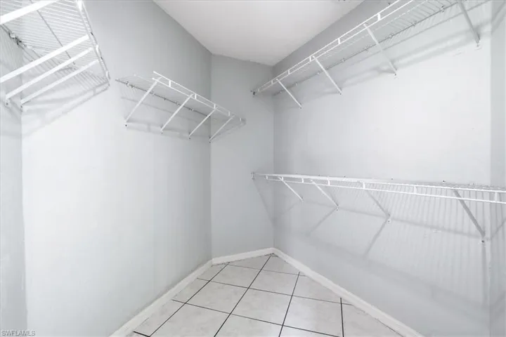 Walk in closet with light tile patterned floors