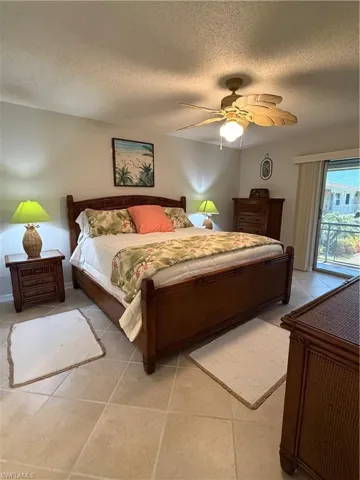 Tile flooring extends into the sleeping area featuring a ceiling fan with integrated lighting