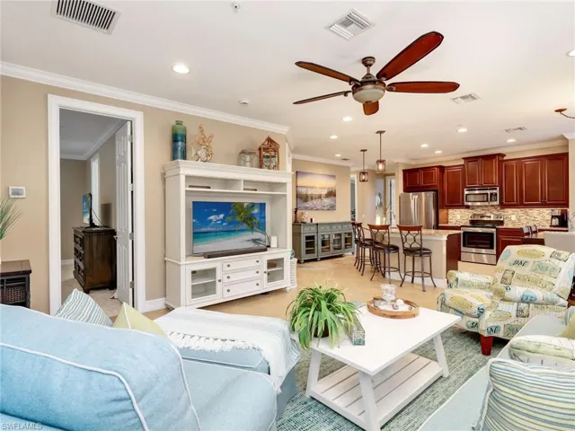 Open Great Room with Crown Molding, Primary Bedroom with Ensuite, Granite Countertops, Breakfast Bar, 42" Solid Wood Cabinetry, Stainless Steel Appliances & Double Sink, Tile Backsplash, and Pendant Lighting