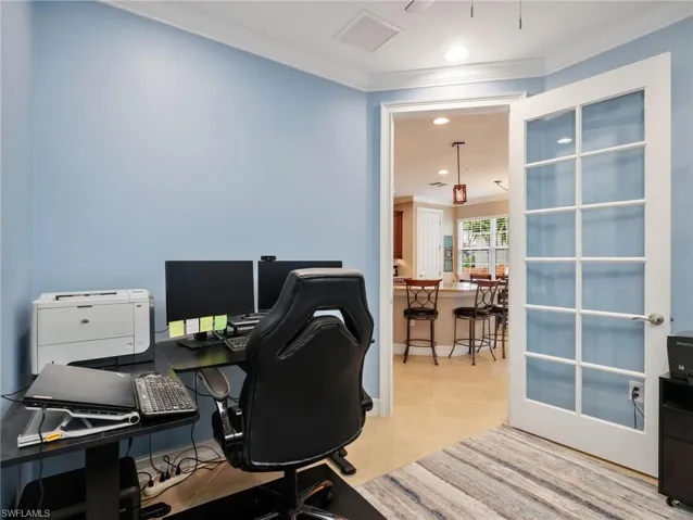 Den with Crown Molding and Glass Paneled Door