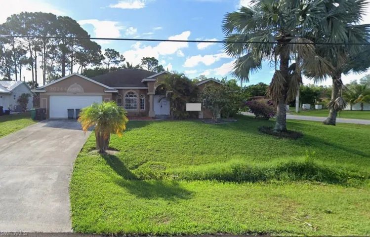 Single story home with concrete driveway, a front lawn, a garage, and stucco siding