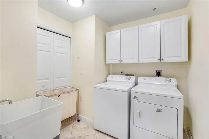 Storage cabinets above washer and dryer and laundry room sink